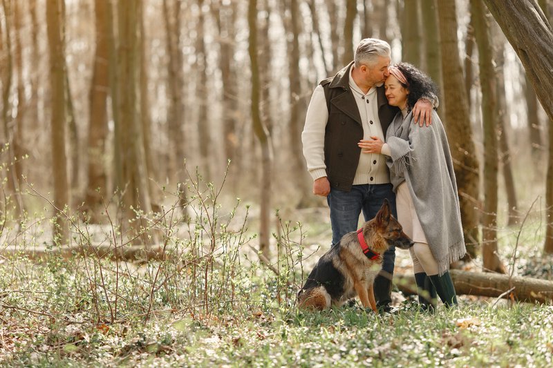 elderly couple walking with dog